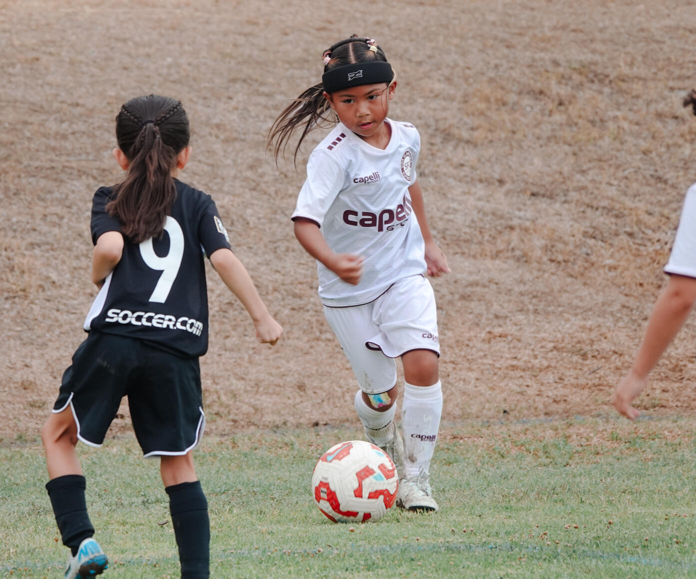 Remy Mariano Remy Mariano dribbling a soccer ball against an opponent.